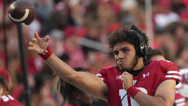 Wisconsin freshman quarterback Myles Burkett warming up on the sidelines.